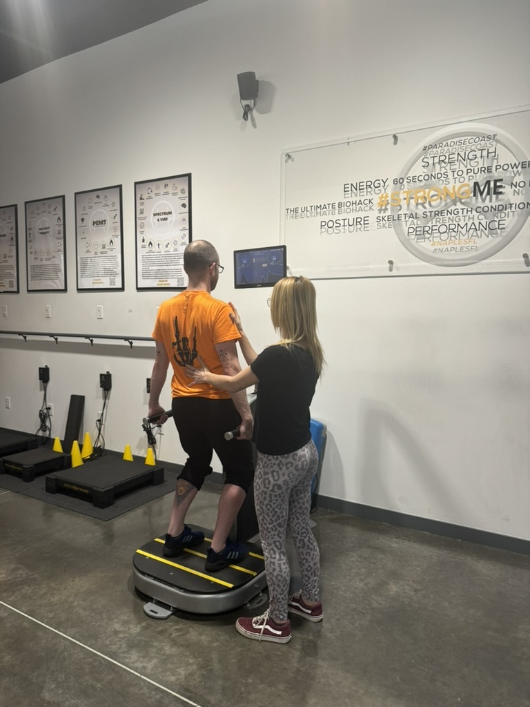 A coach guiding a member on the Postural Growth Trigger
