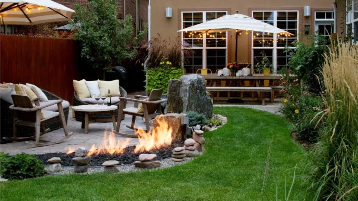 Beautifully designed outdoor fire pit by Hardscape Denver on a paved patio