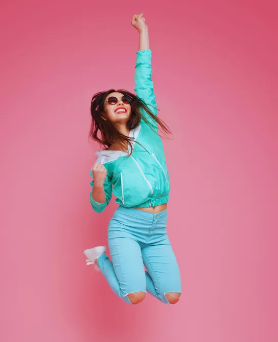 A woman jumping for joy because she is fearless and free
