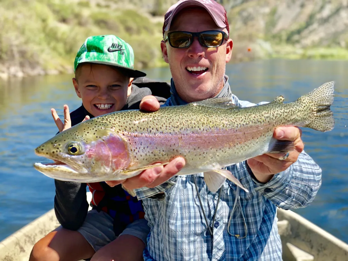 Darrel DeLeon guiding Vice President Mike Pence as he casts a fly line into a flowing Montana river, with Darrel ready to net the catch.