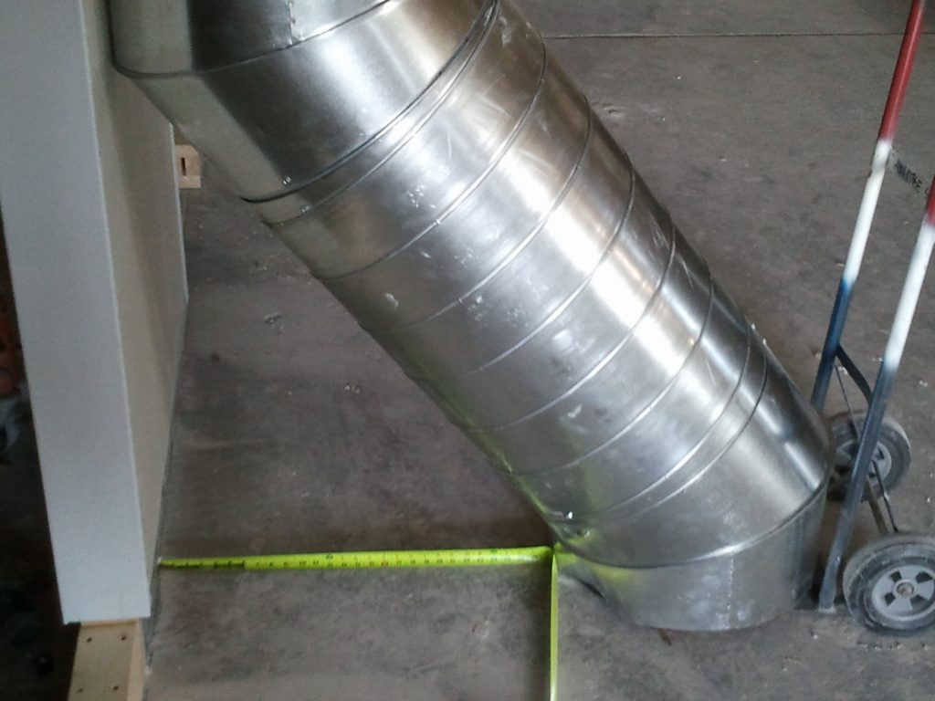 Large commercial HVAC ductwork unit installed on a rooftop, showing industrial-grade duct fabrication and installation.