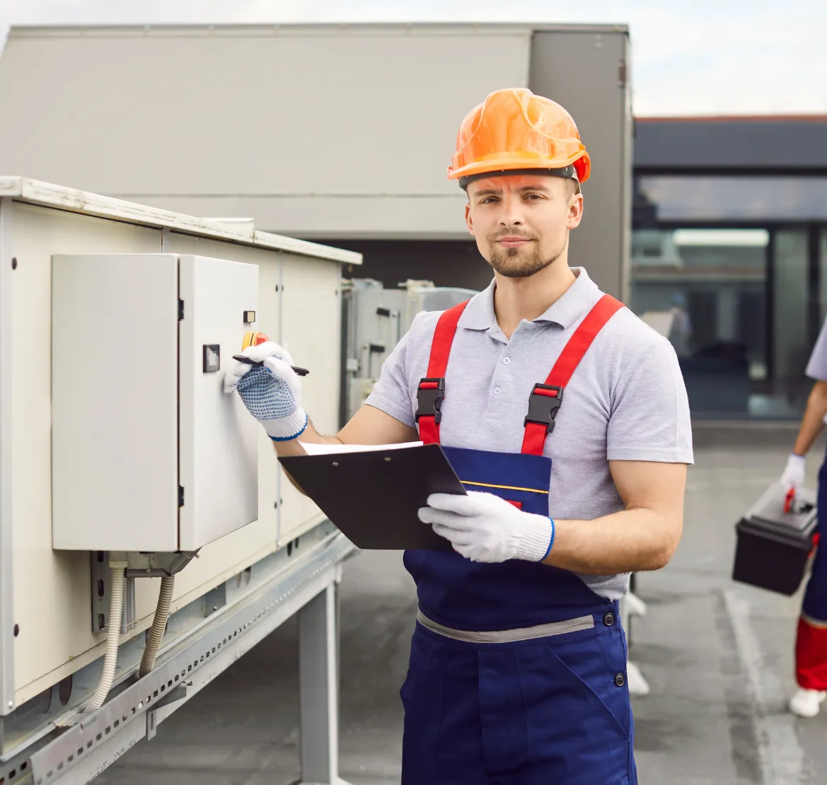 HVAC engineer standing near industrial duct system.