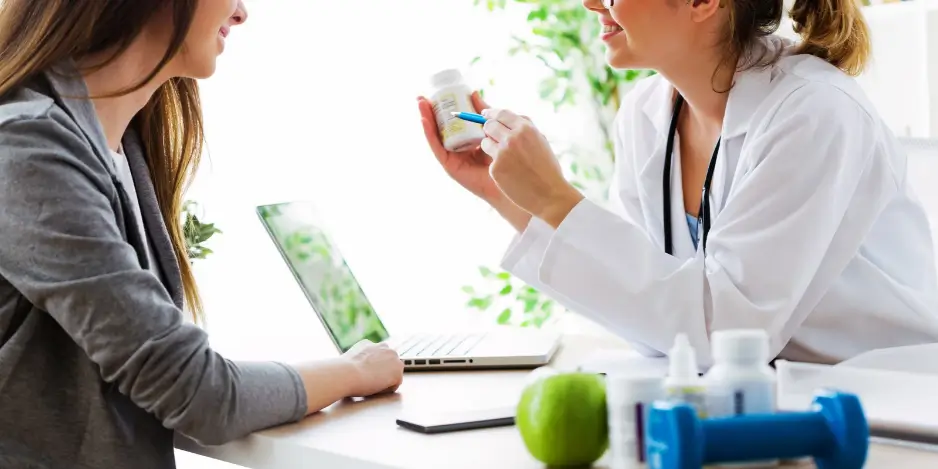 Healthcare professional reviewing vitamins and supplements with a patient
