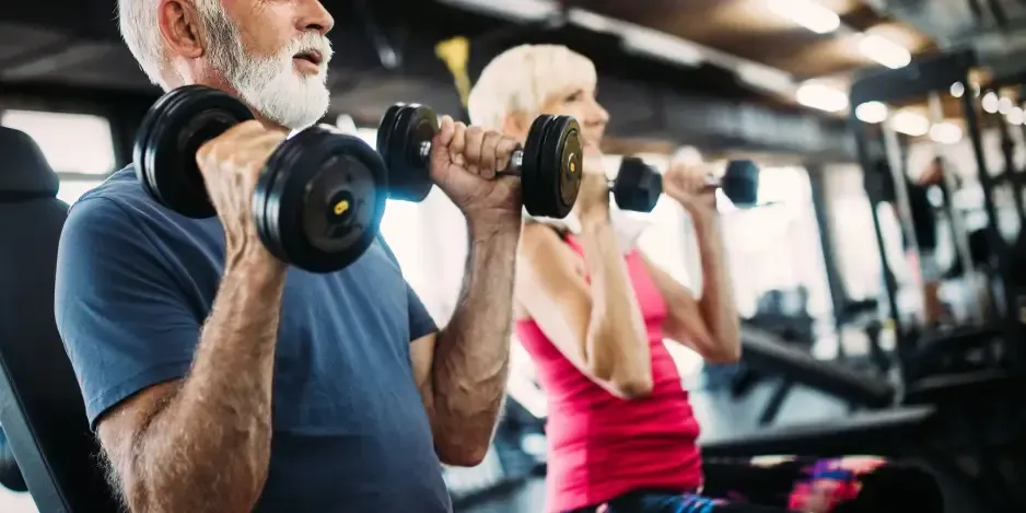 Senior couple doing dumbbell weight training for bone health and osteoporosis prevention in Cincinnati, OH.