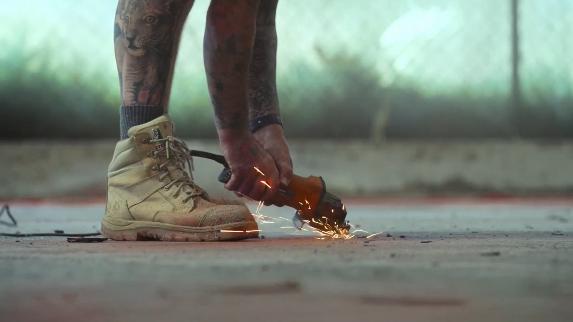 concrete grinding using small handheld orange tool