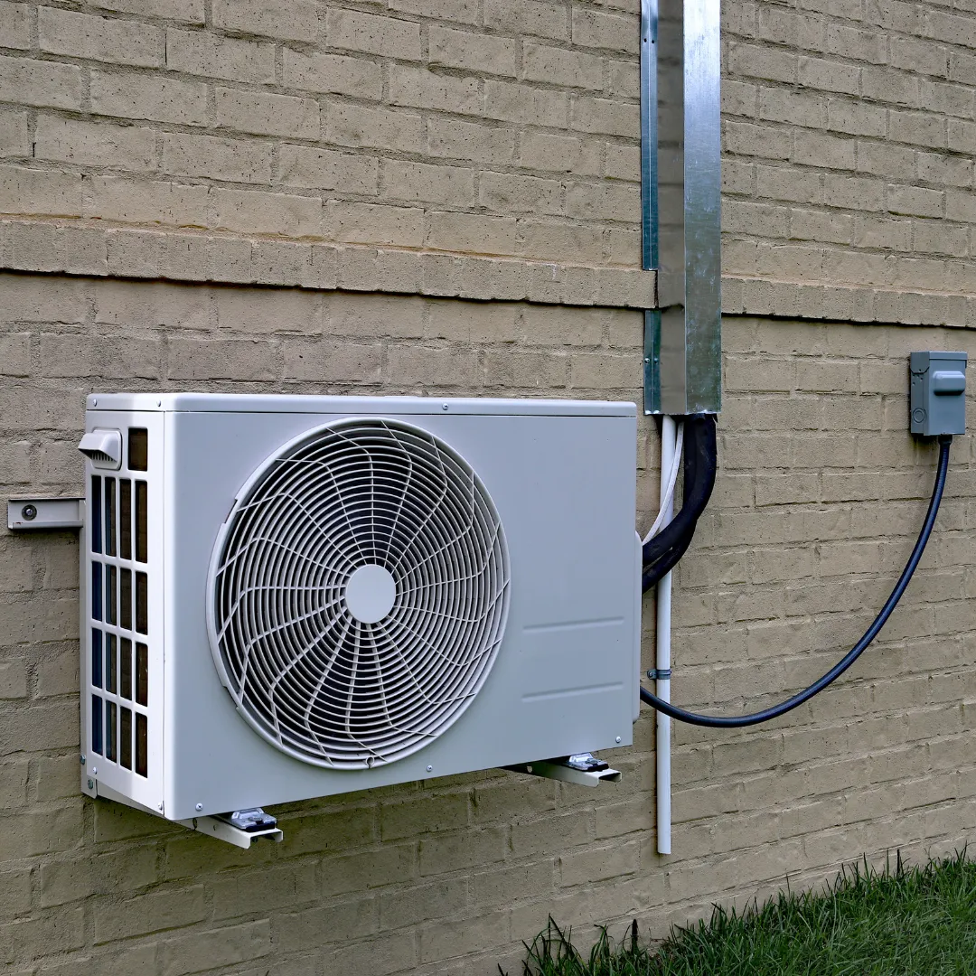 Air conditioning unit installed on the side of a house for efficient cooling.
