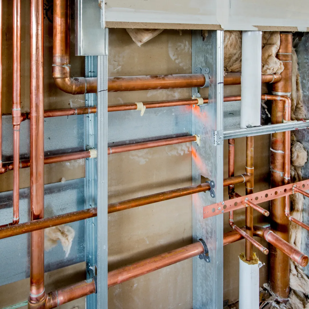 A plumber performing rough-in plumbing for a new construction project, ensuring the system is accurate and up to local code standards.