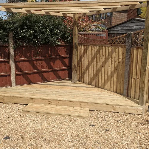 Wooden pergola and fence installation with decking base in Bournemouth garden