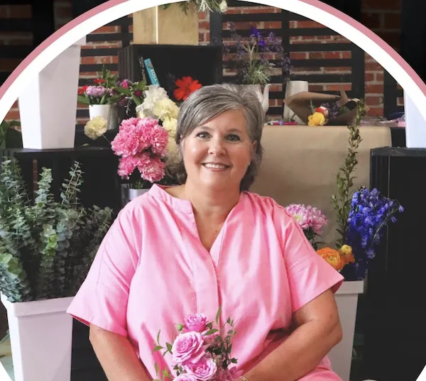 Candid portrait of Susan 'Moo' Hawkins arranging fresh flowers in her studio