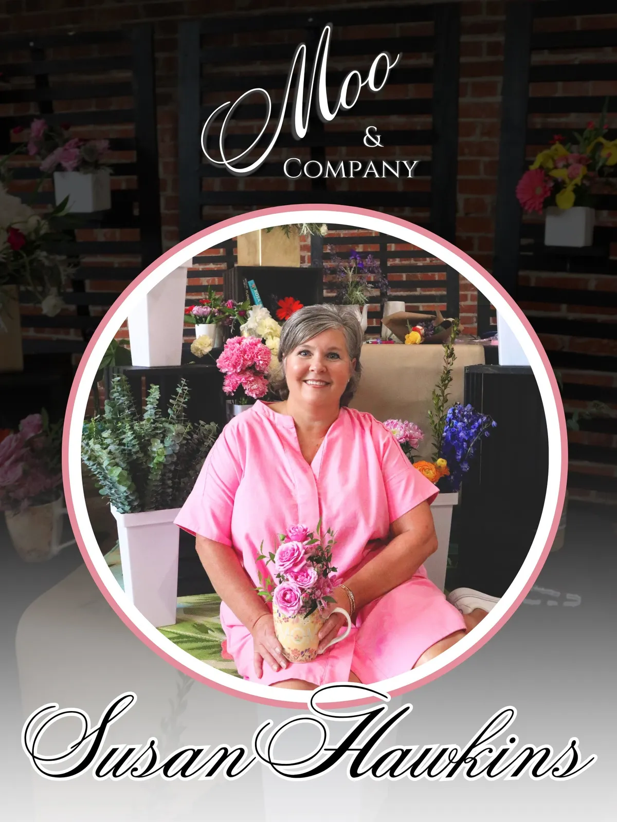 Moo and Company owner smiling and arranging fresh flowers in the local Hixson shop