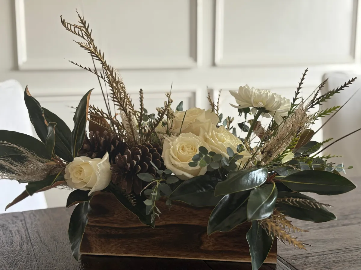 White sympathy arrangement with peonies in a gold vase