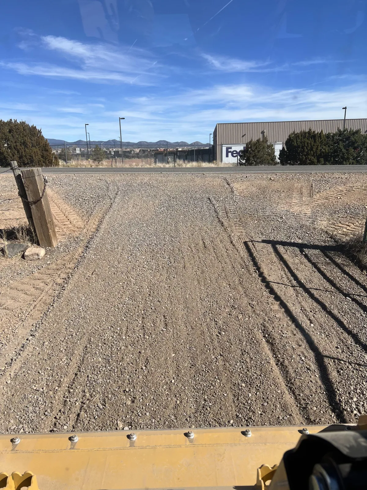 Excavator doing rough and finish grading
