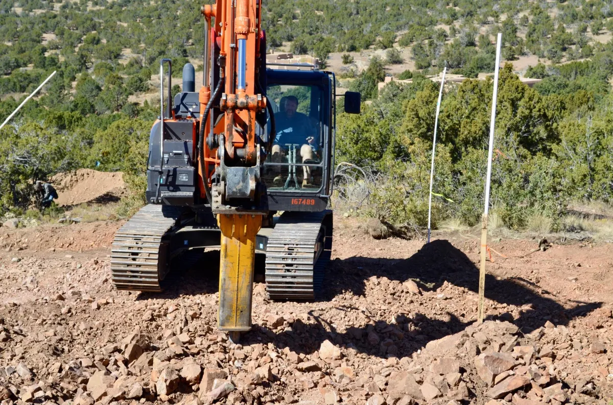 Heavy machinery performing precision trenching