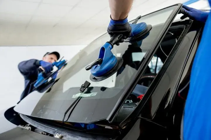 Mechanic installing a new car window