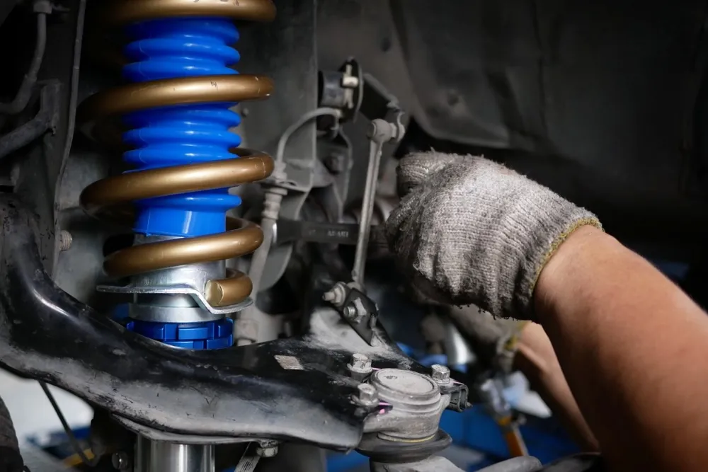 Close-up of a blue suspension spring and shock absorber on a car