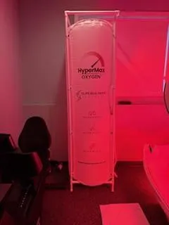 man in red jacket riding on boat on lake during foggy weather