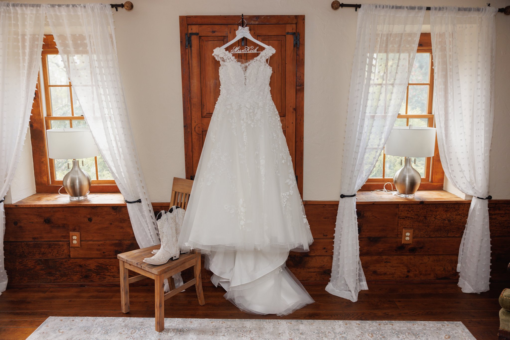 Elegant view of the bride’s dress hanging in the bridal suite - Gangi Photography