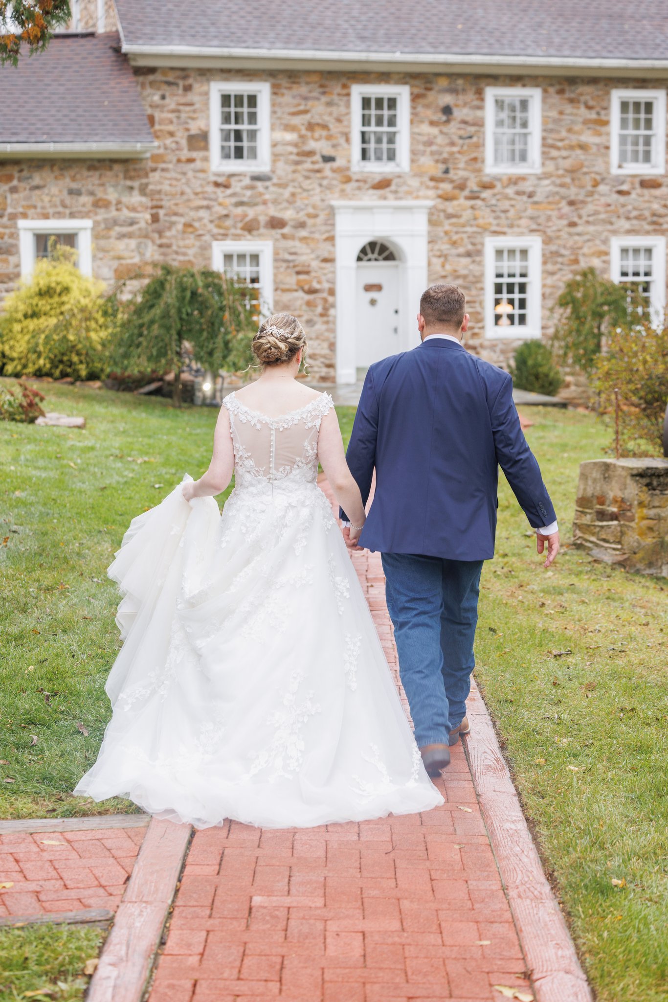 Newly married couple walking down a path after the wedding ceremony - Gangi Photography