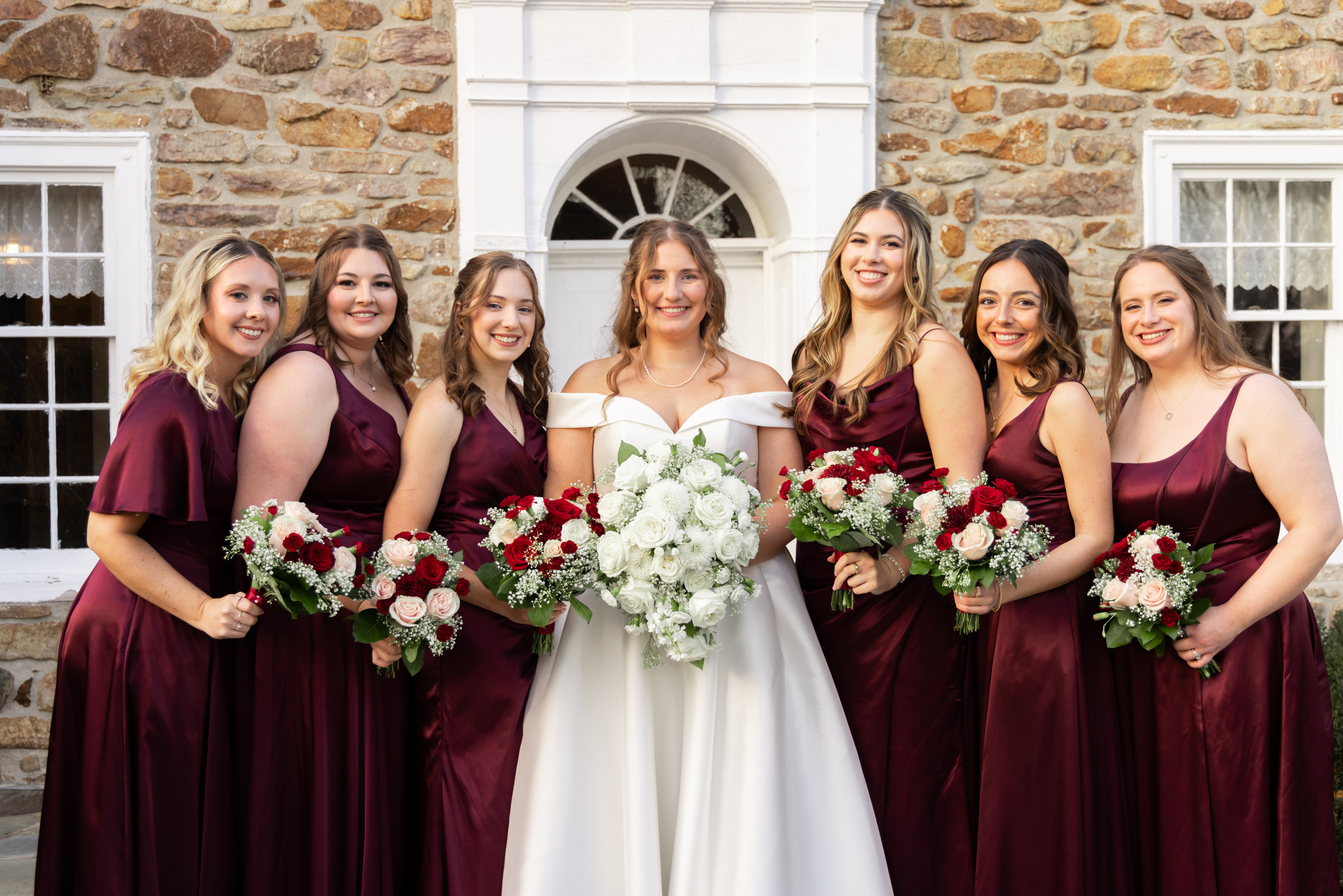Bride posing with her bridesmaids in a group portrait - TM Weddings Photography
