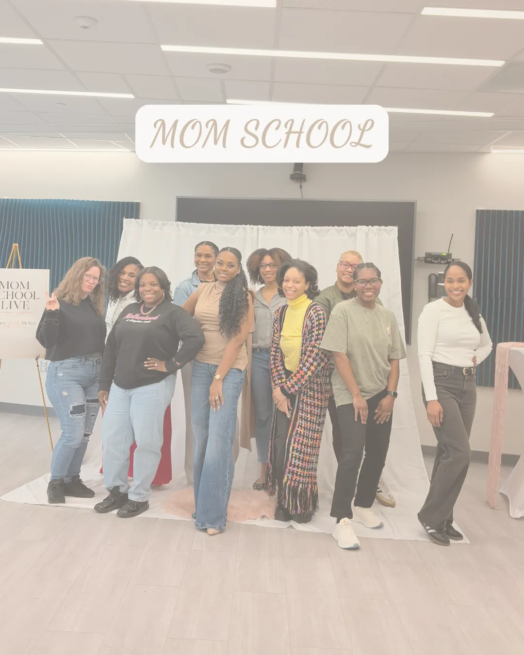 Group of moms smiling together at a Mom School Live event representing encouragement, growth, and community for mothers.