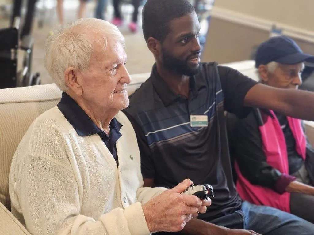 Resident and team member playing video game