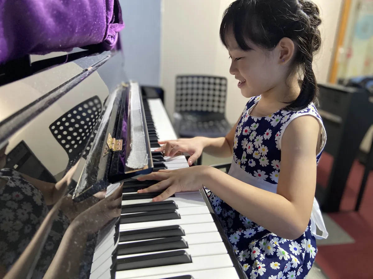 Child leaning to play piano