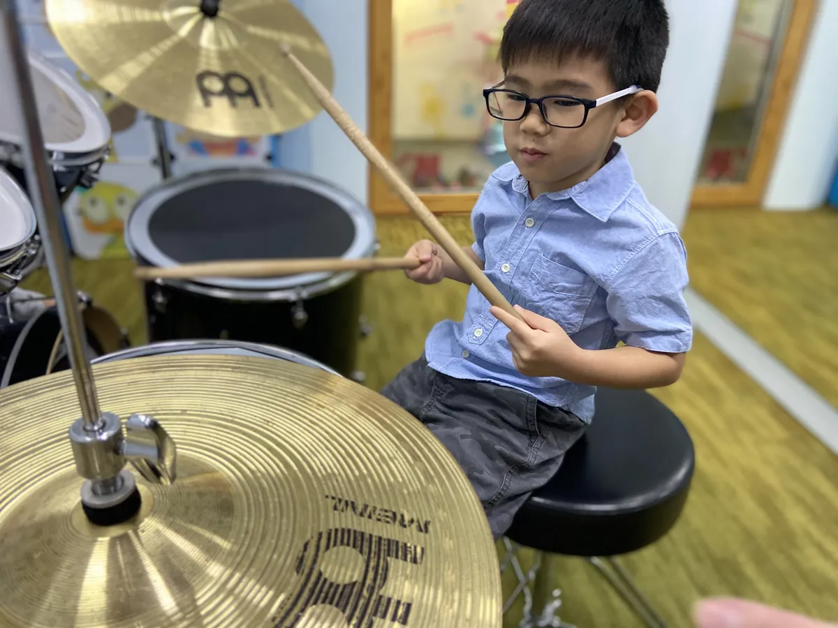 Children leaning to play drums