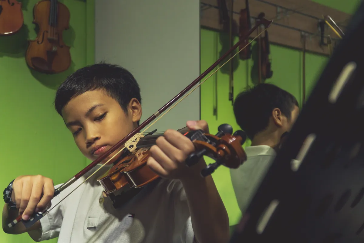 Children learning how to play the violin