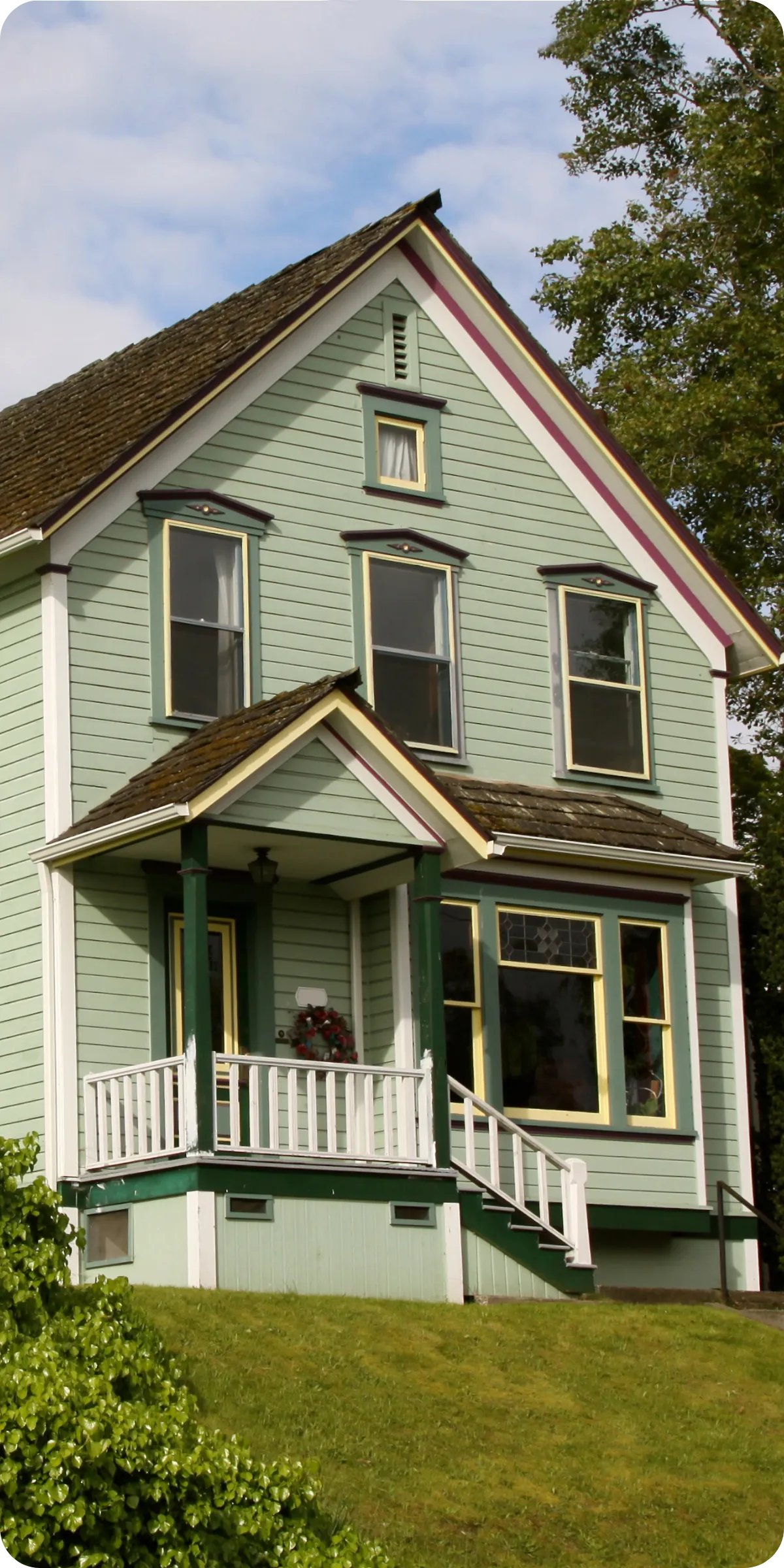 Historic green home with classic architecture in Fort Collins, CO — representing detailed antique and old home inspections focused on preservation and safety.