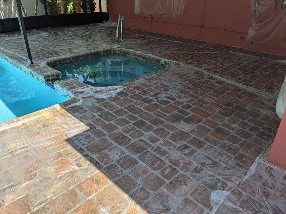 Brick paver pool deck being prepped for stripping failed sealant