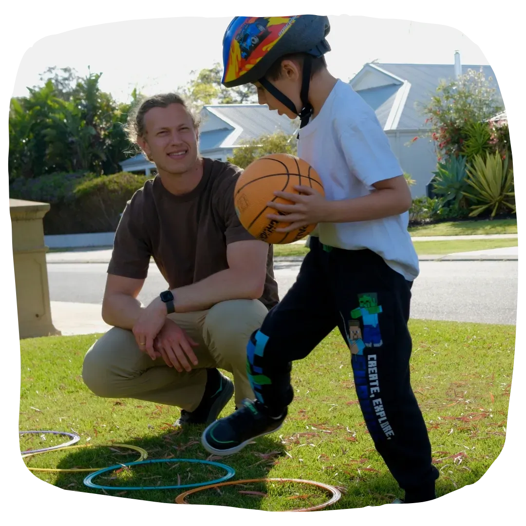 Paediatric Physiotherapist Assisting Kid Ride a Bike