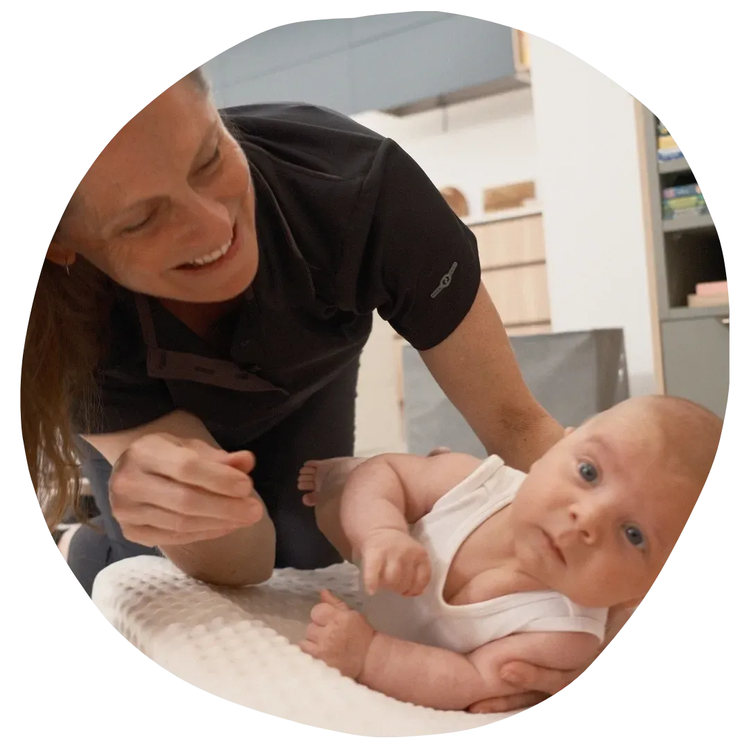 Paediatric Physiotherapist Assisting Kid Ride a Bike
