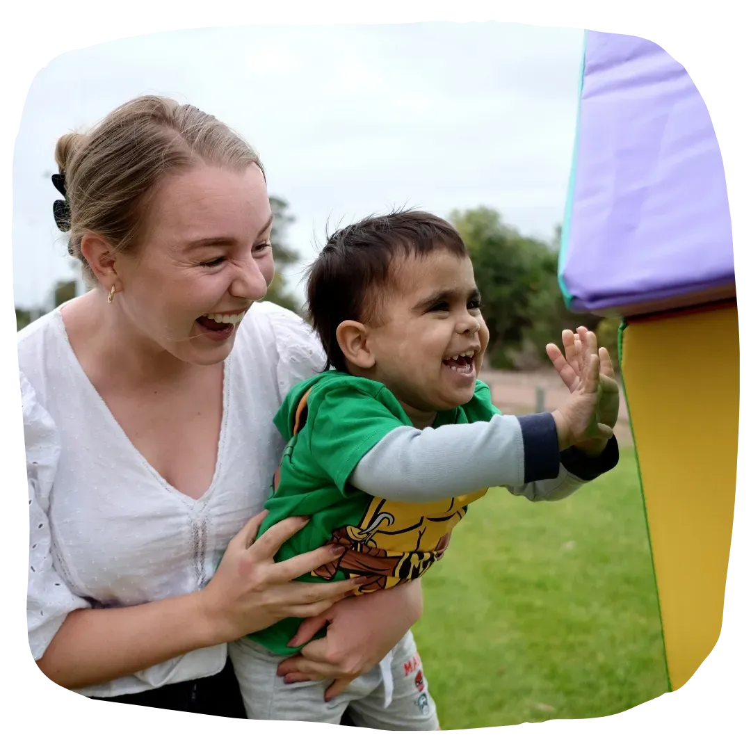 Paediatric Physiotherapist Assisting Kid Ride a Bike