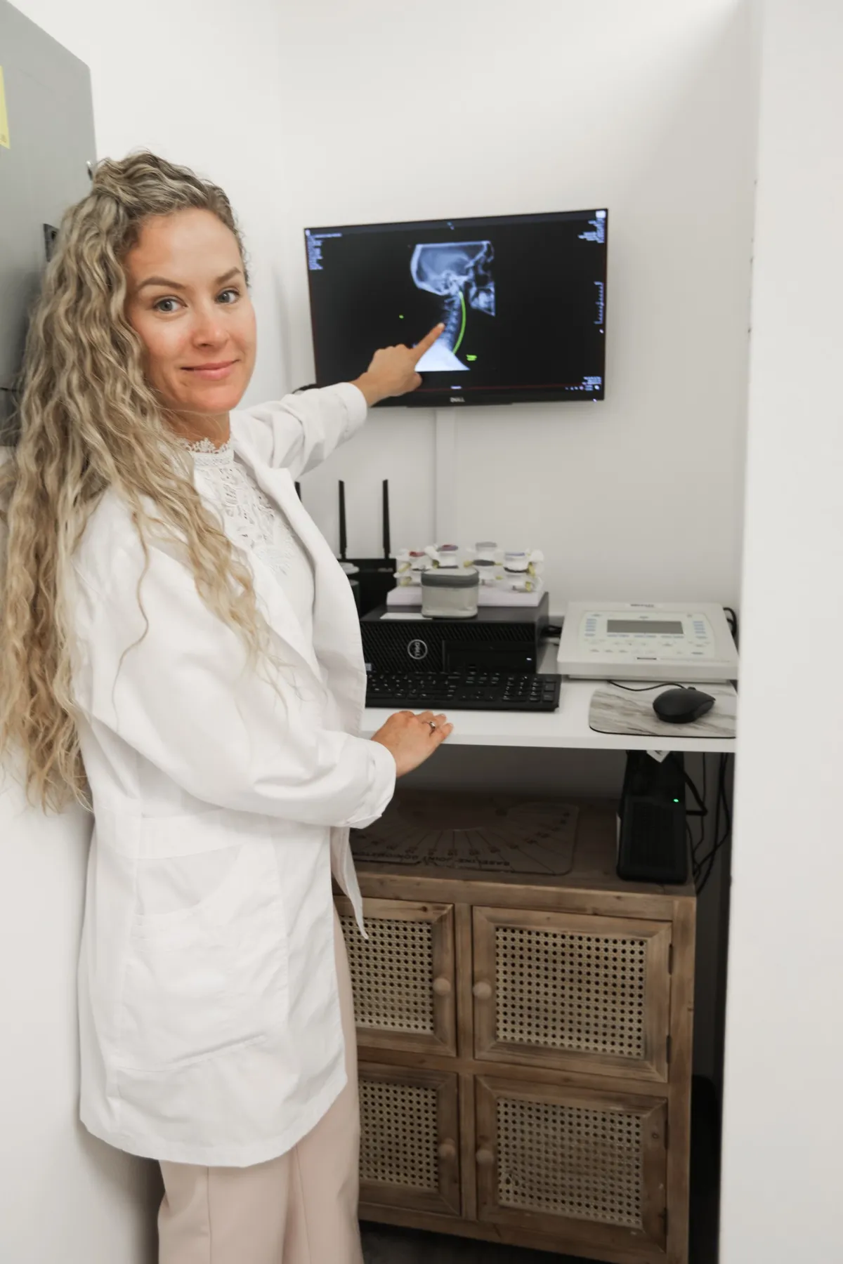 Clinical photo of Dr. Jessica reviewing high-resolution digital spinal X-rays at Vitality Chiropractic