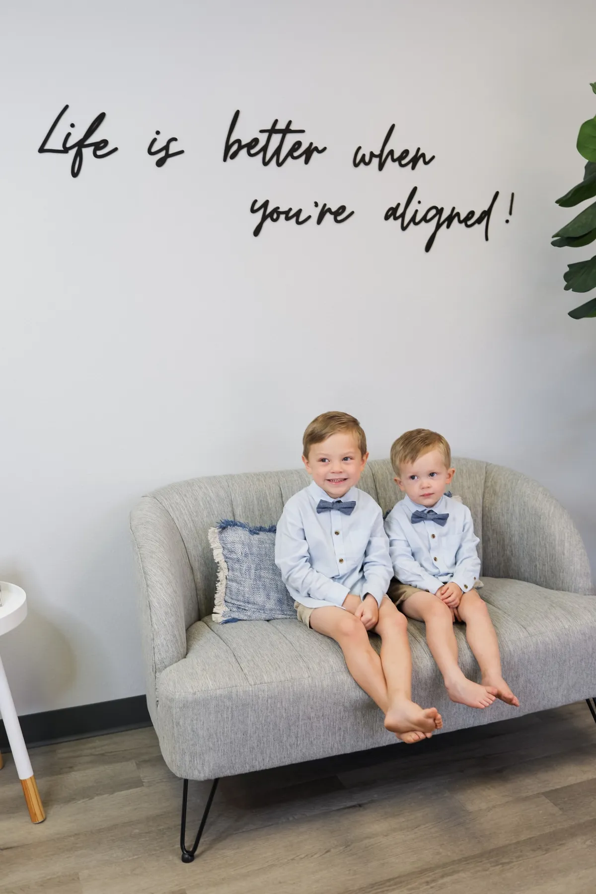 Dr. Juan and Dr. Jessica with their sons Leo and Laith in a warm clinic family portrait