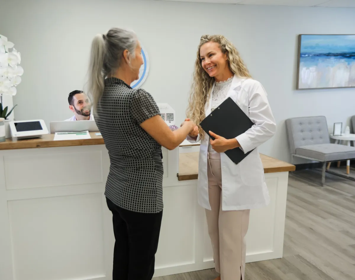Doctor of Chiropractic gently adjusting patient spine in Sarasota clinic