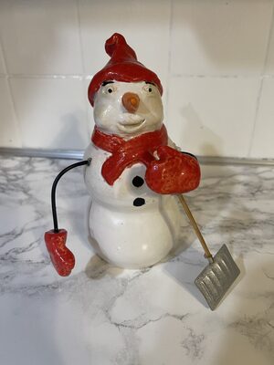 Snowman with snow shovel