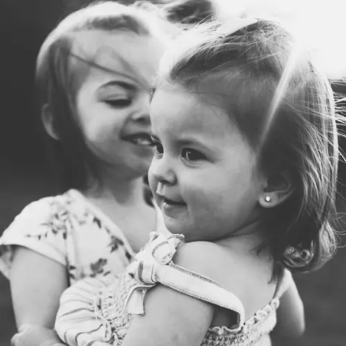 Candid shot capturing sisters dancing, taken by Hannah Melson Photography