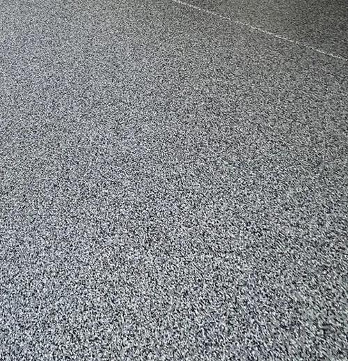 Close-up of gray epoxy flake concrete coating texture