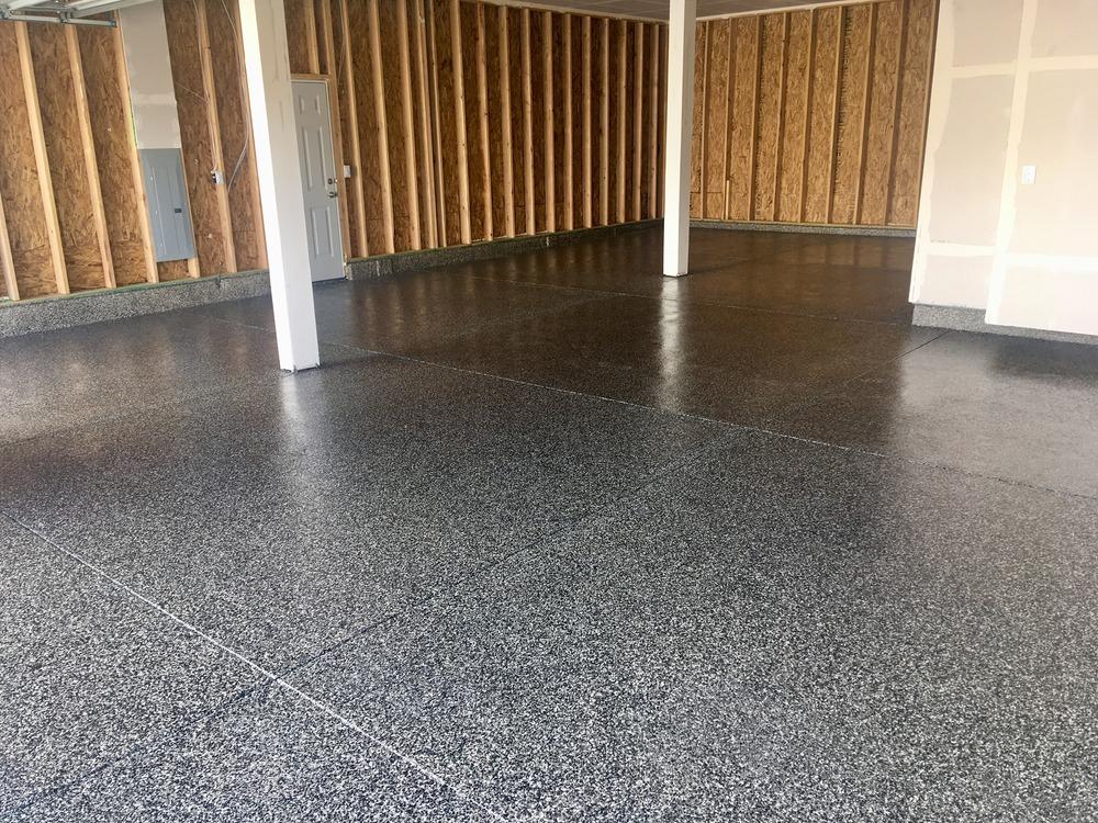 Decorative epoxy flake flooring installed in residential garage space