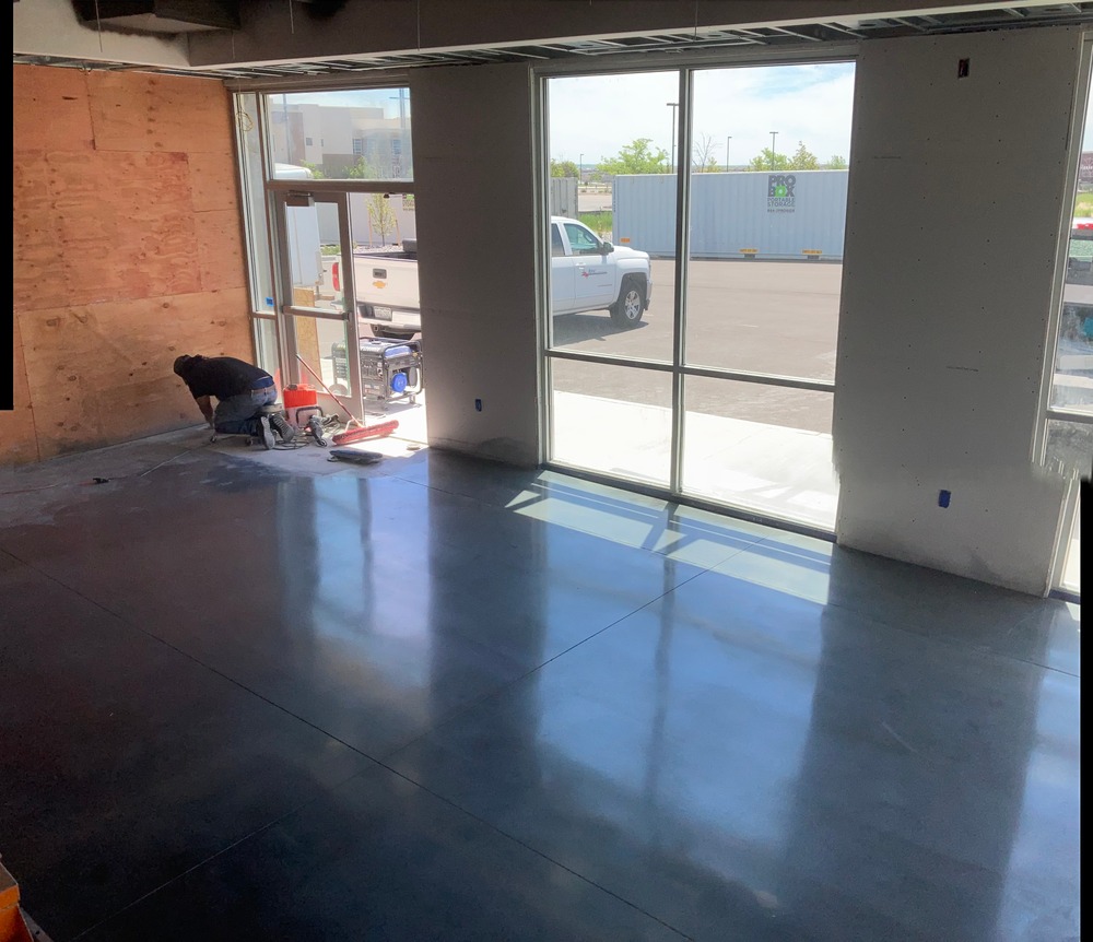 Polished concrete floor inside commercial space with natural light