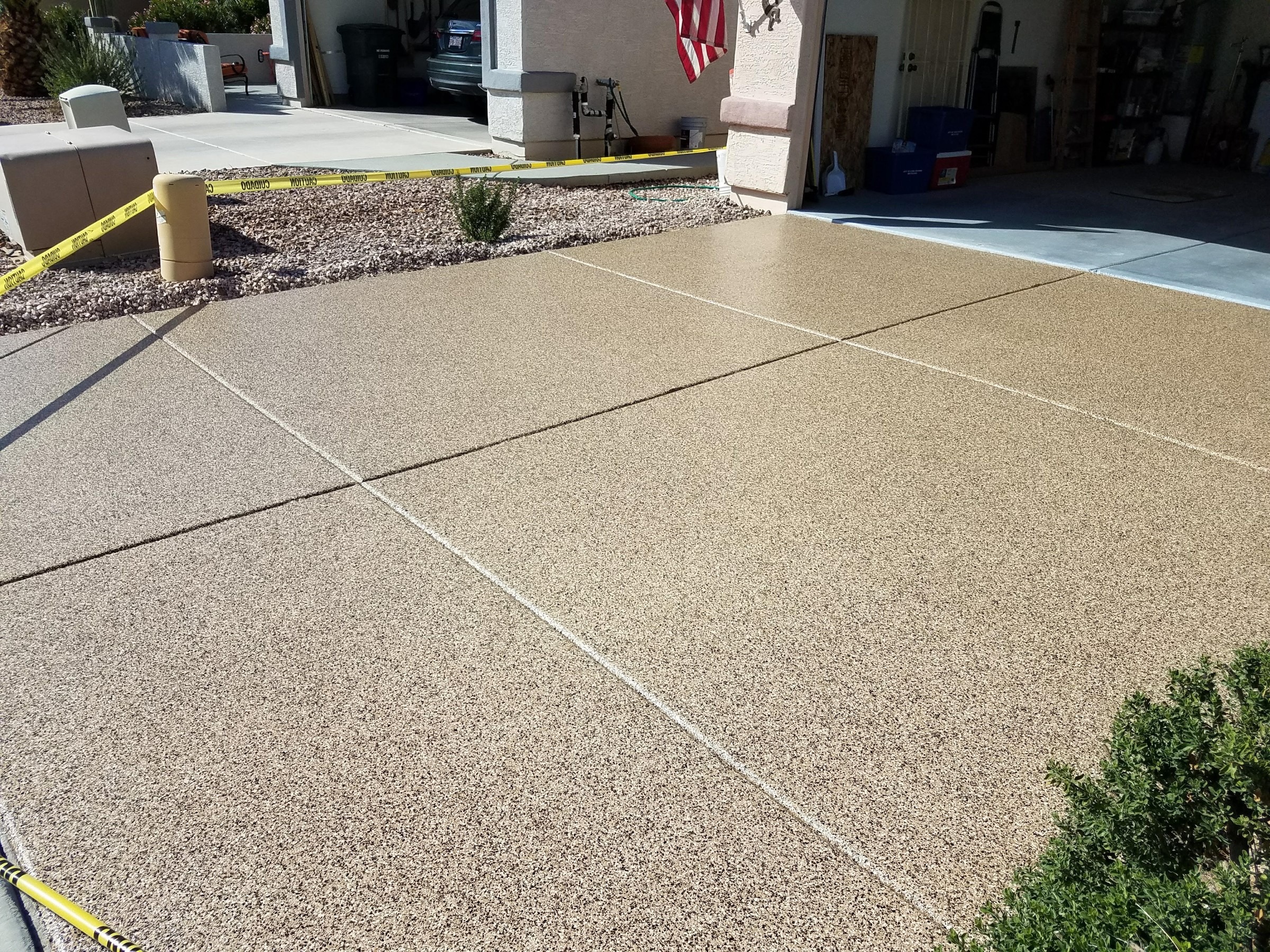 Outdoor driveway with textured concrete coating and expansion joints