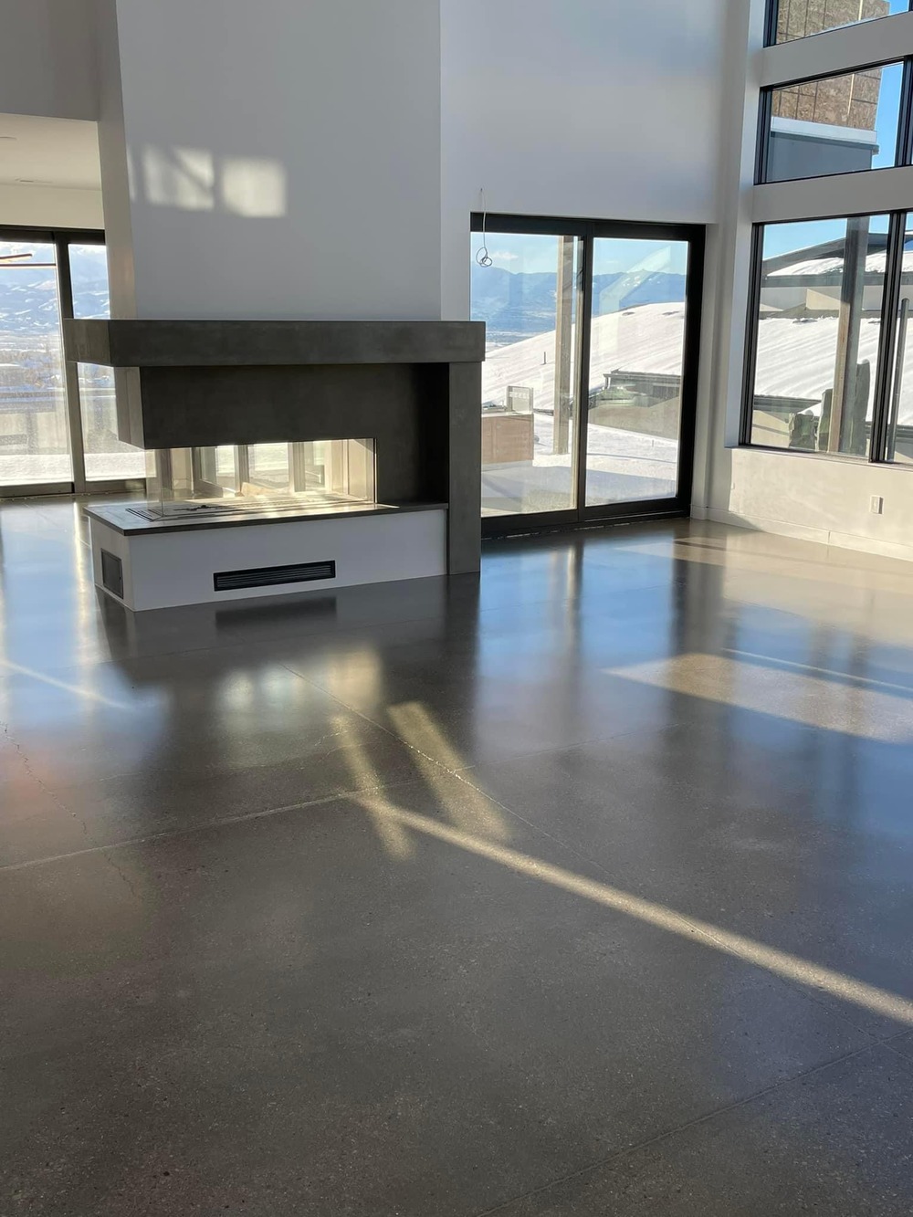 Modern home interior with polished concrete floor and natural light