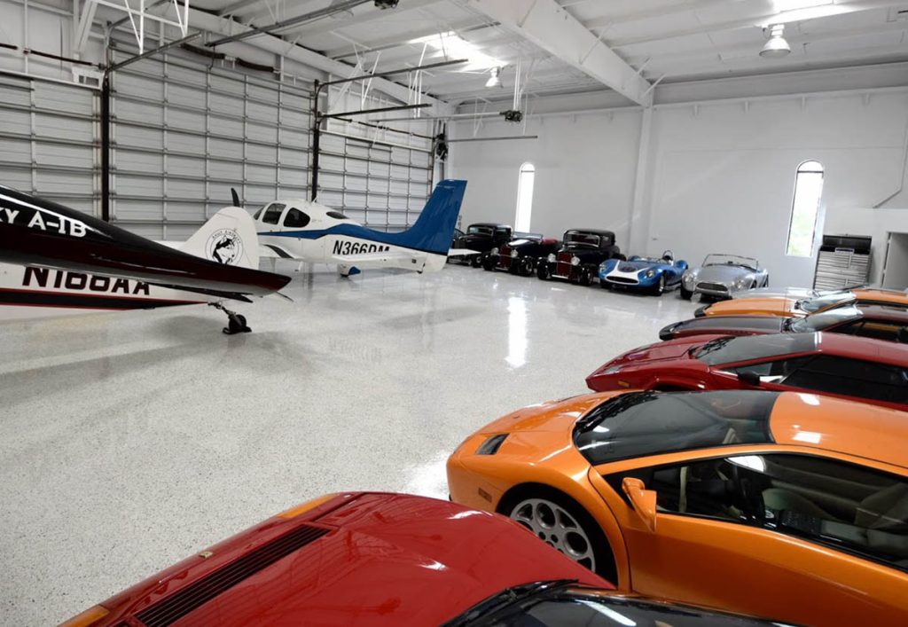 Commercial epoxy floor inside aircraft hangar with vehicles and polished finish