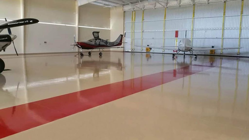 Aircraft hangar with epoxy flooring and safety striping