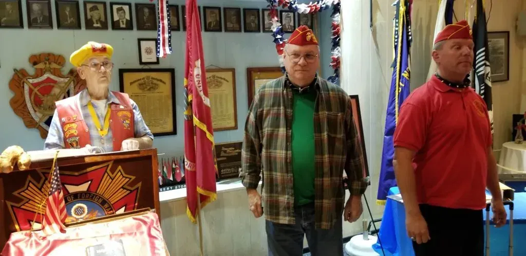 Pound Keeper Ben Pfister welcomes Bob Nelson and Brent Kast into the Military Order of the Devil Dogs