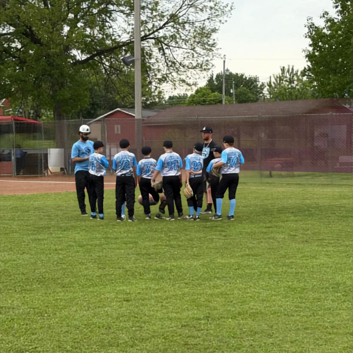 Stallions baseball team huddle showcasing family and competition