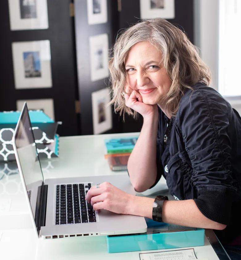 Lisa using a MacBook Pro while sitting at her desk