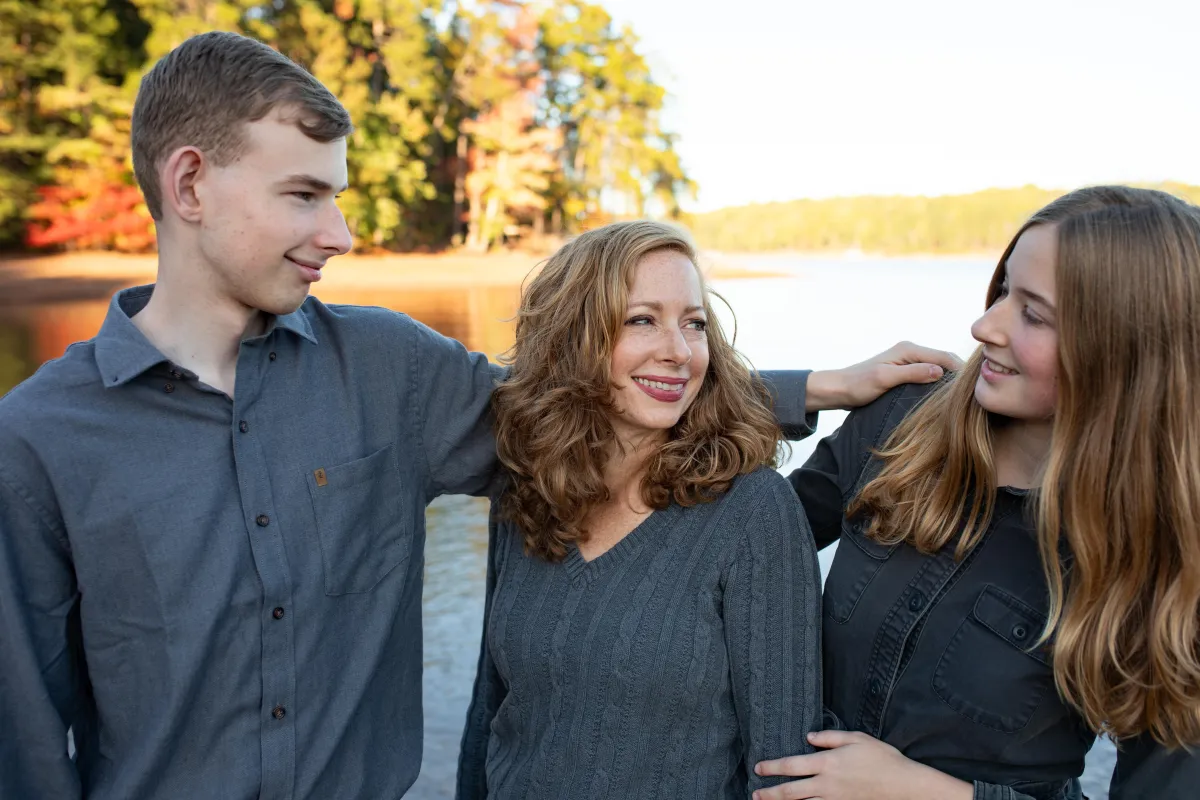 mom and teen son look at teen daugter