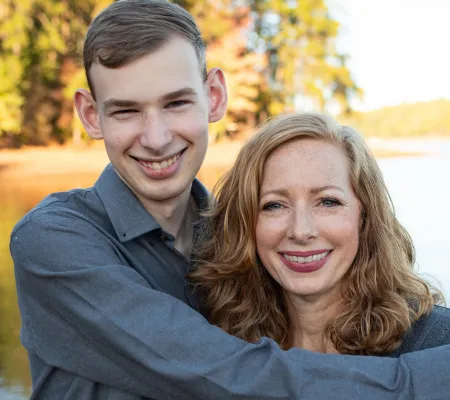 Teen son hugs his mom
